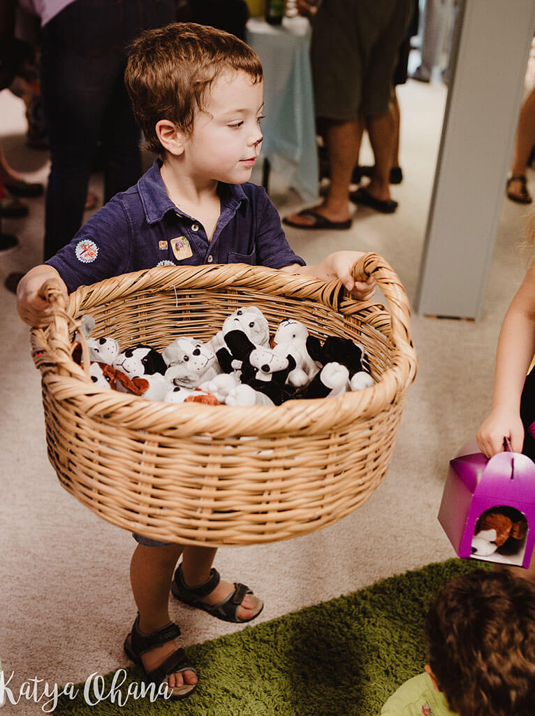 Neta with a basket full of small puppy dolls